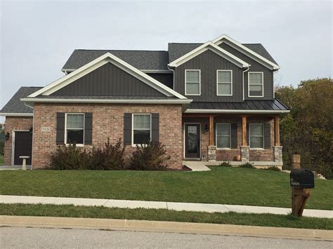 grey house red metal roof|dark grey brick house.